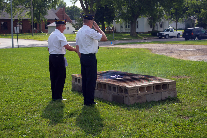Post commander Marv Peters and Scott Droessler oversee retirement of the first flag.